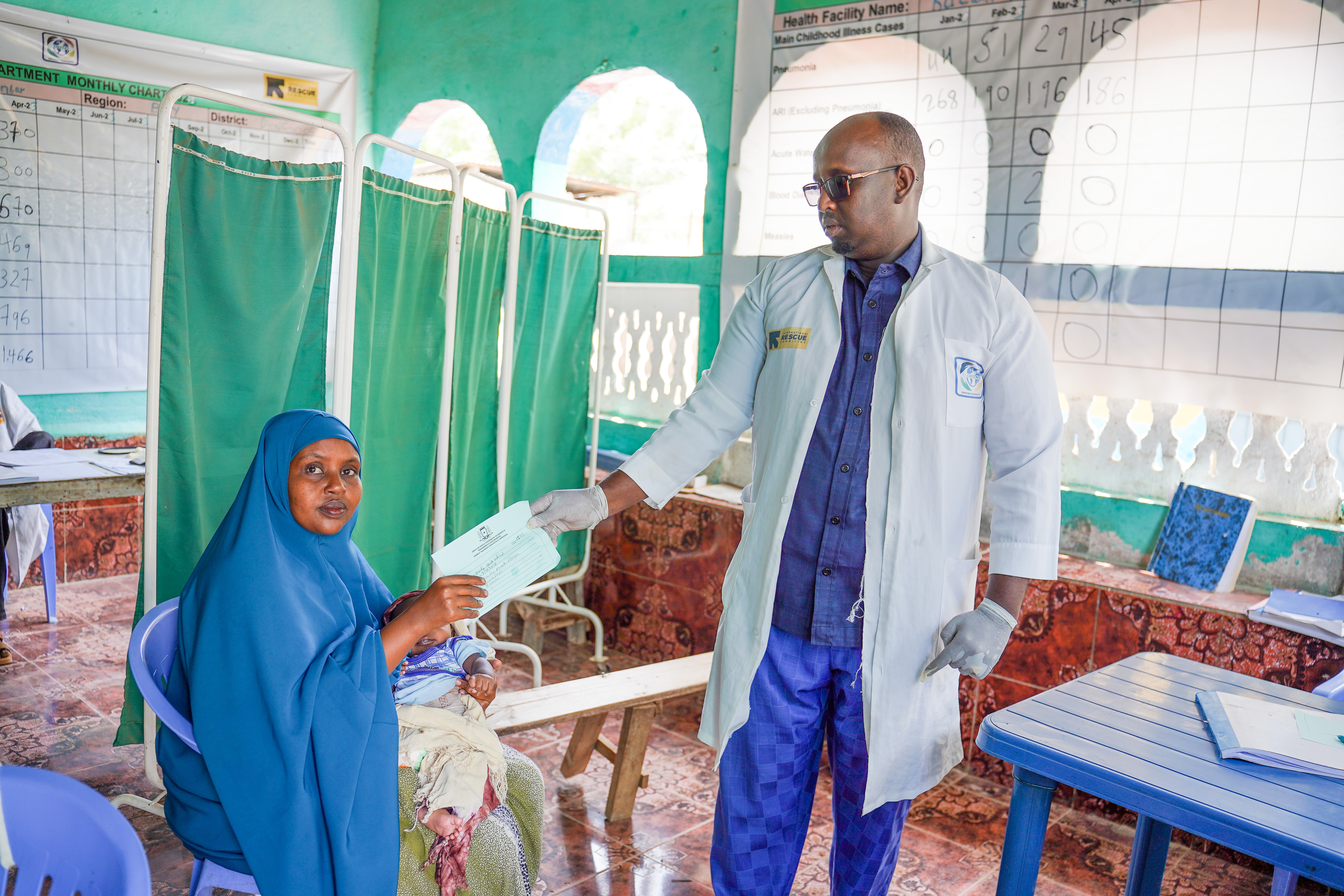 Fartun Ayub Hassan is a mother in Somalia, holding one of her children, Mahir, who received a vaccination for the first time since he was born thanks to the Reaching Every Child in Humanitarian settings (REACH) consortium, funded by GAVI and led by the IRC.