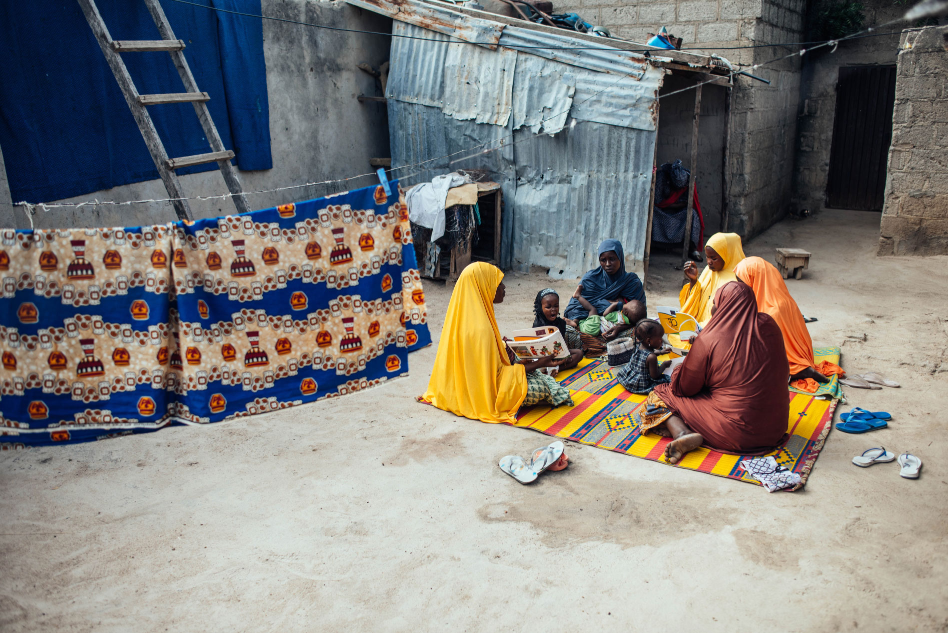 Lead mother and entrepreneur Hauwa Mustapha, 30, interacts with other women during mother-to-mother support  session within their community at Sulubri, Maiduguri, Borno, Nigeria.