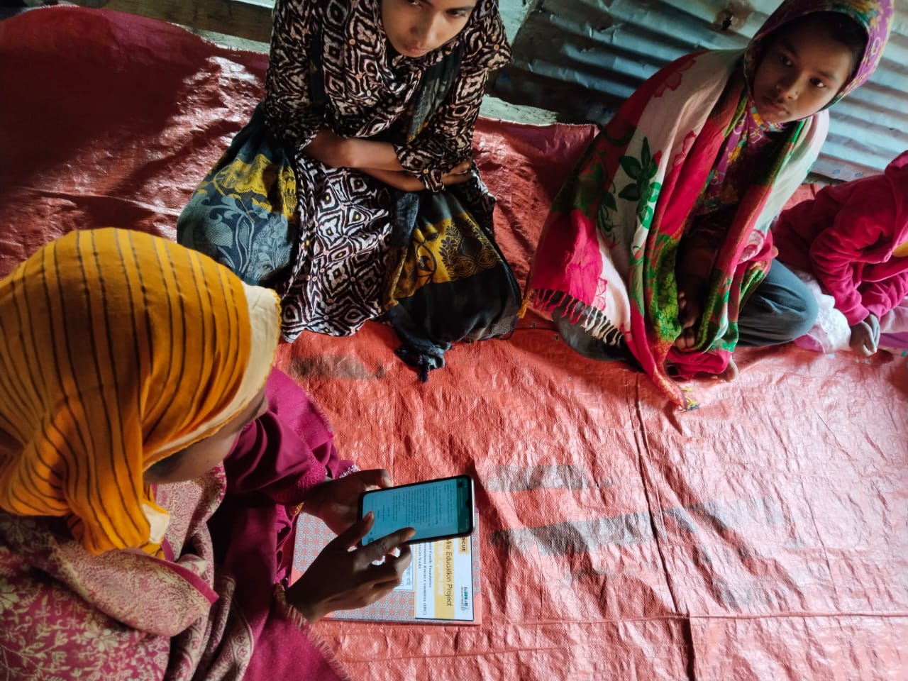 Teacher using aprendIA Onneshi chatbot in Bangladesh with her students.